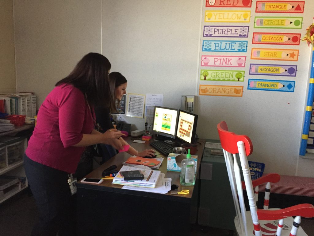 Ashley Moore and Stephanie Harbaugh set up LanSchool, a classroom computer management tool